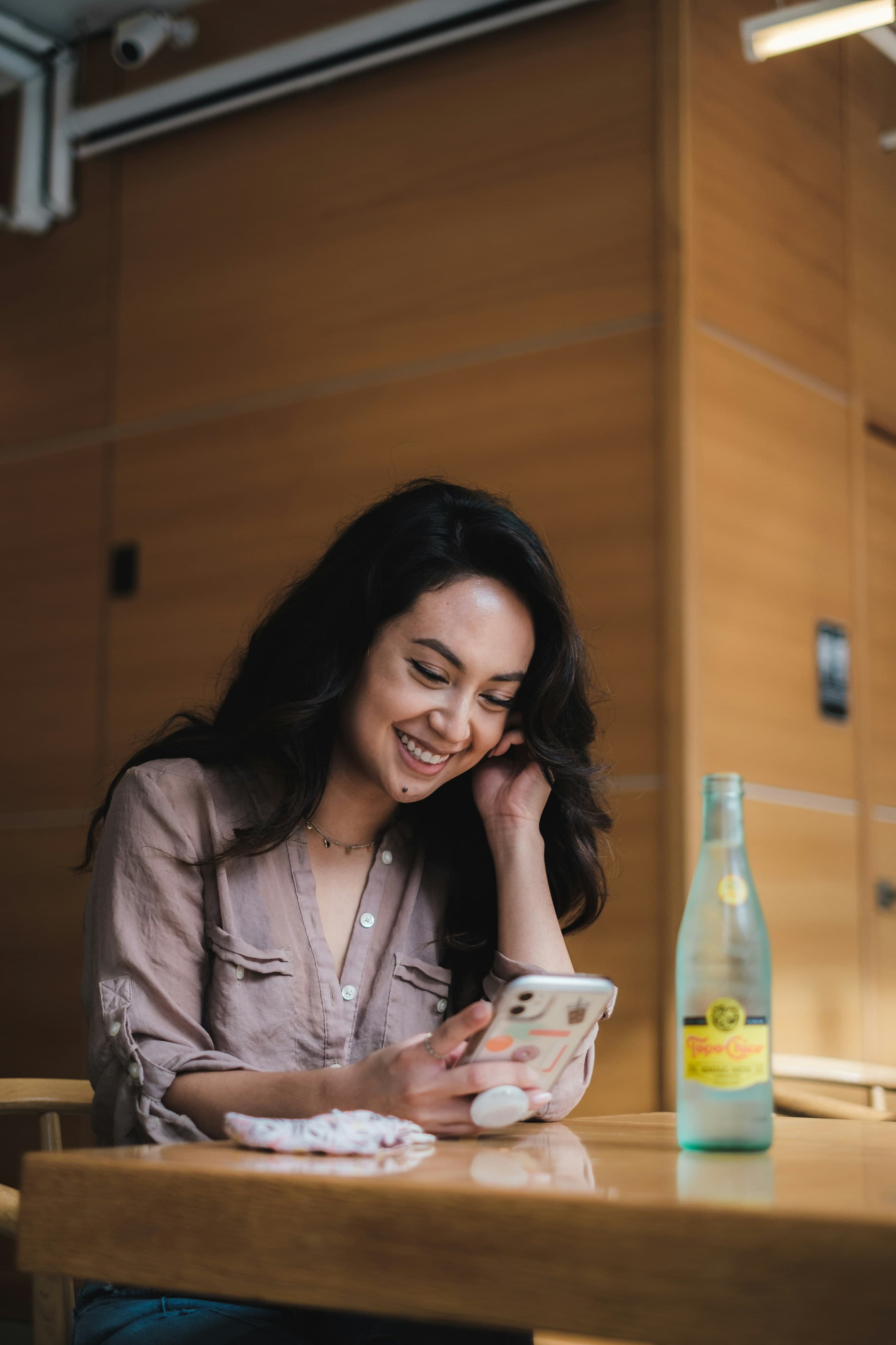 Woman smiling while using her phone